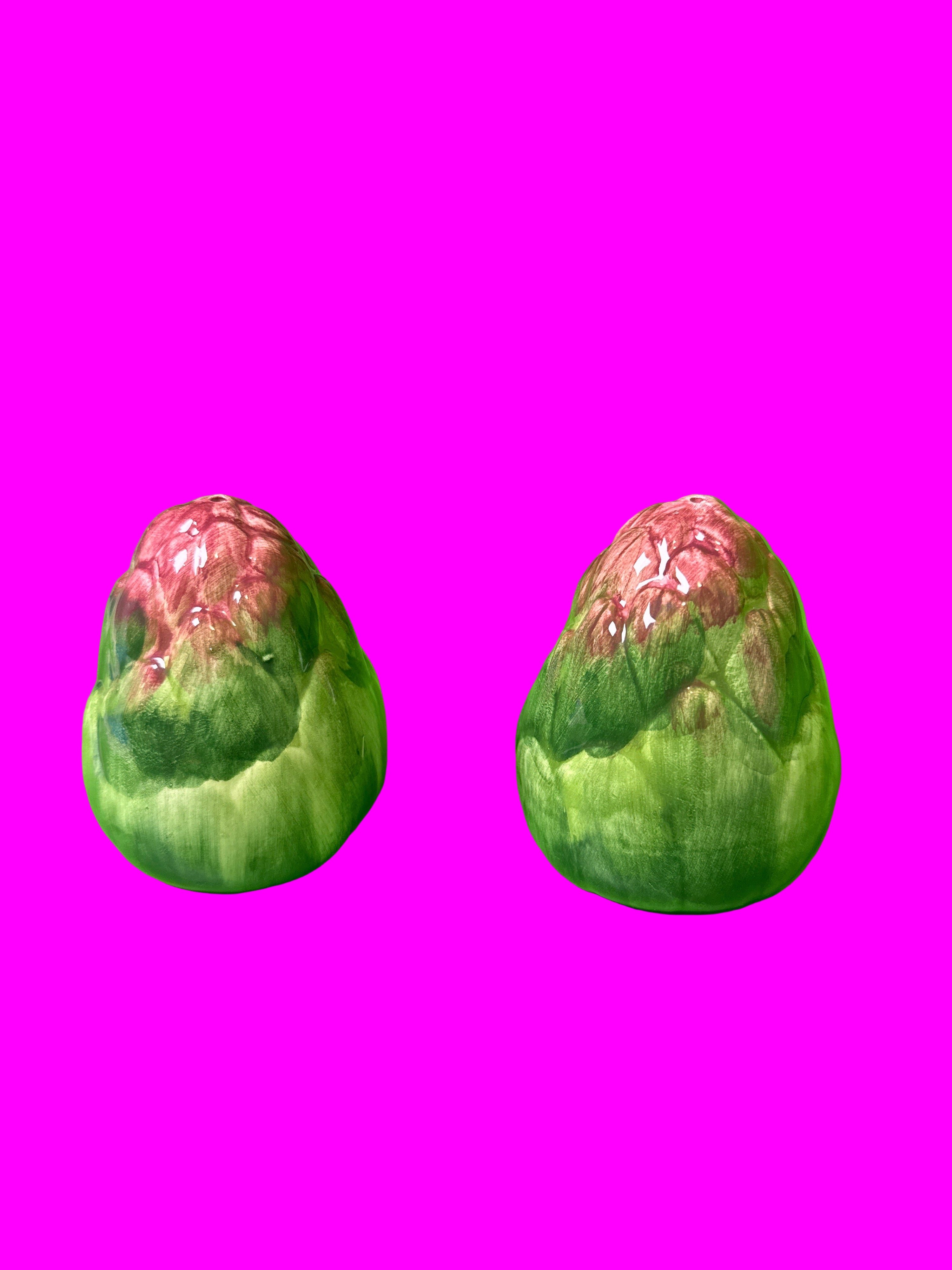 Two green and pink artichoke salt and pepper shakers 