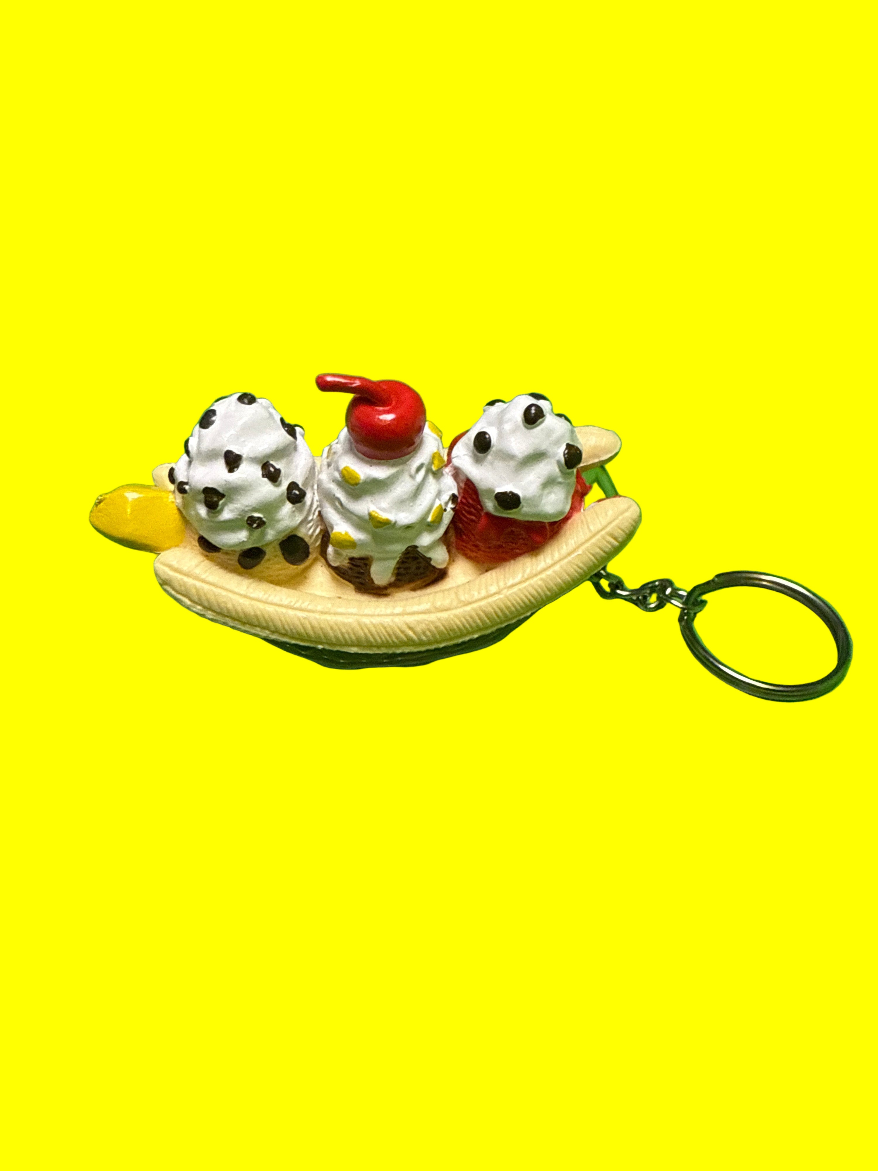 Keychain shaped like a banana split on yellow background
