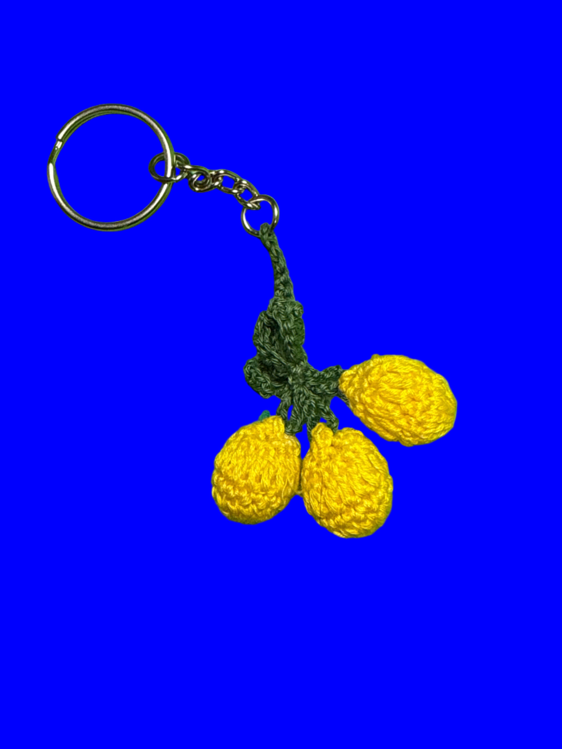 Crocheted yellow lemons on a blue background
