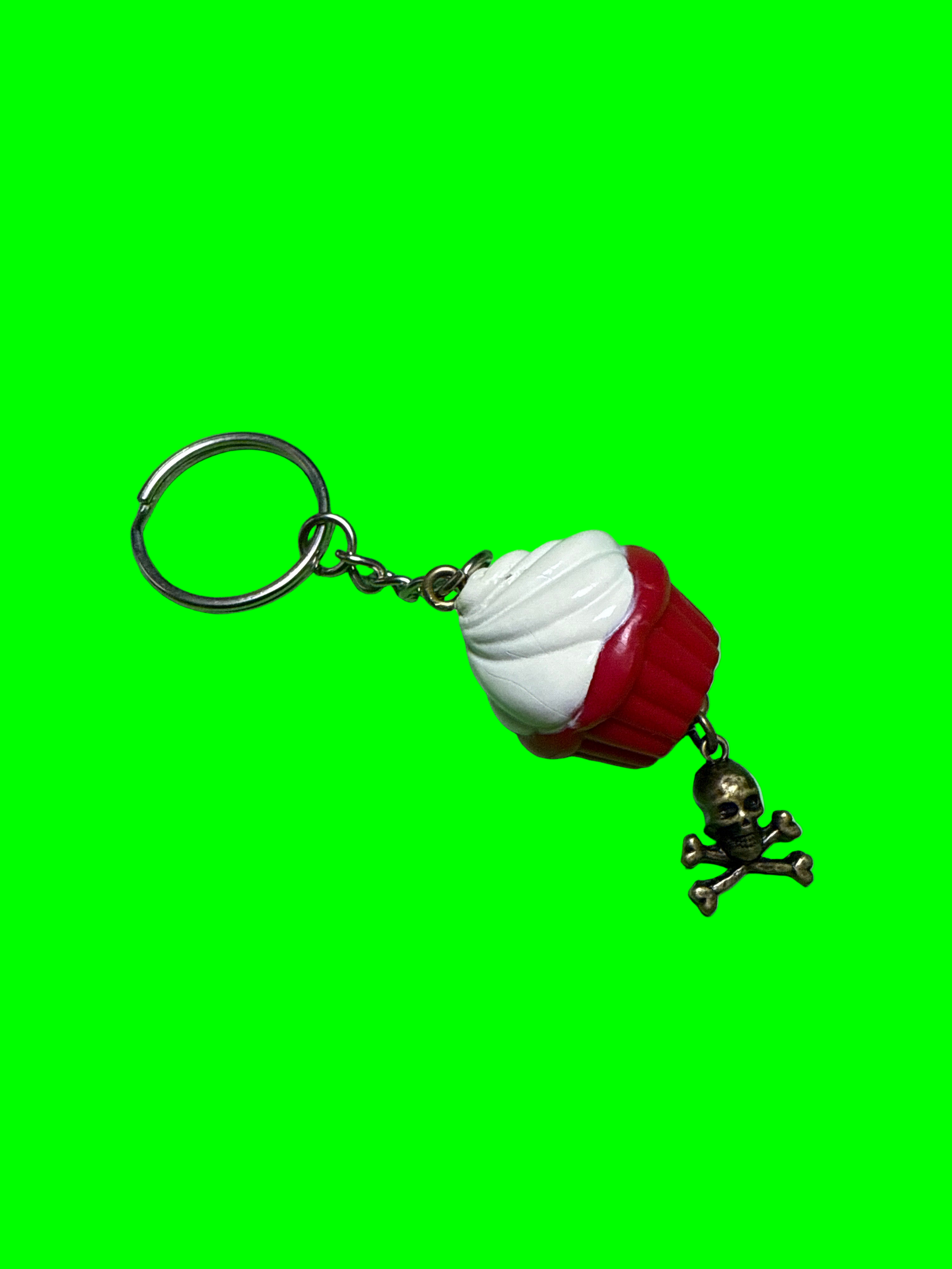 Keychain with a cupcake and smile on a green background