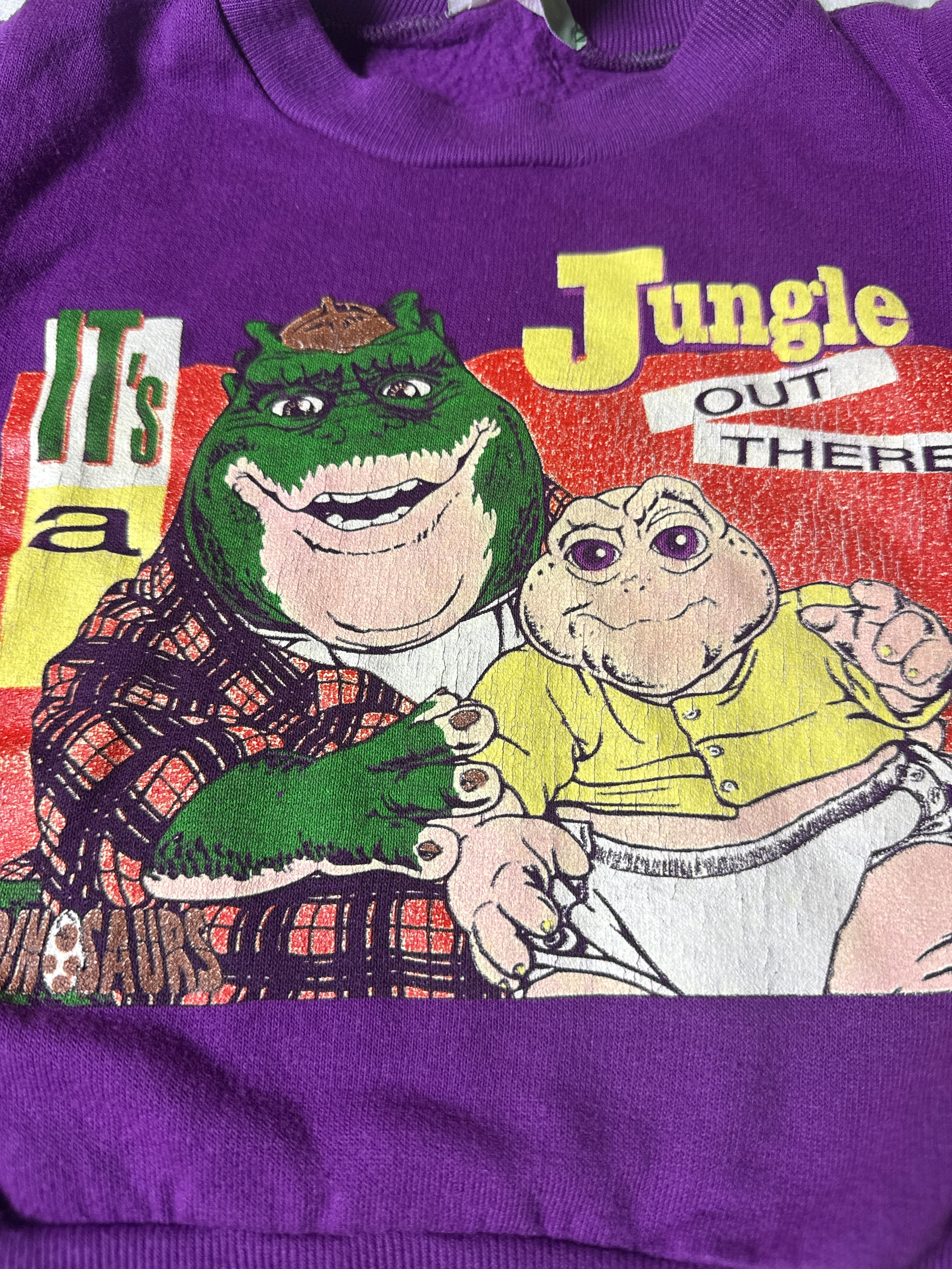 Purple sweatshirt with a cartoon character and 'Jungle Out There' text on a colorful background