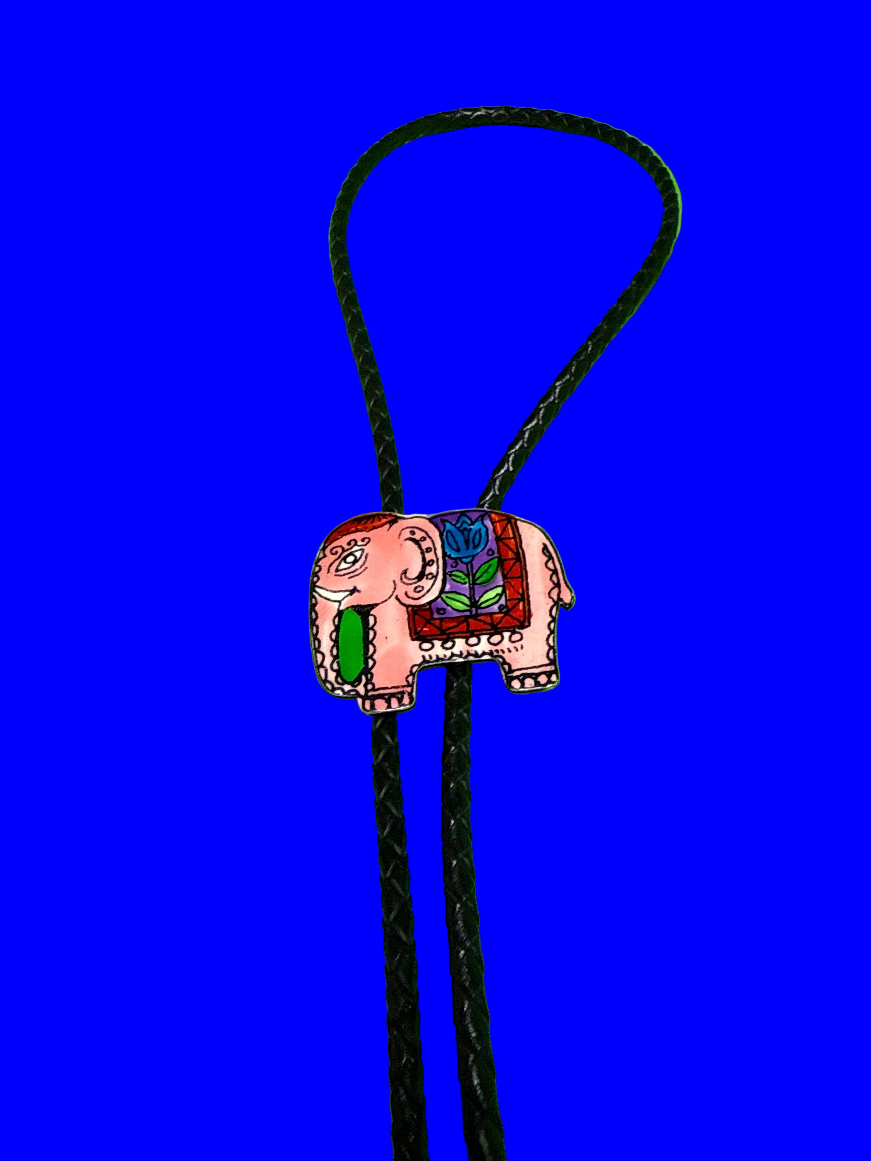 Vintage elephant bolo tie on a blue background